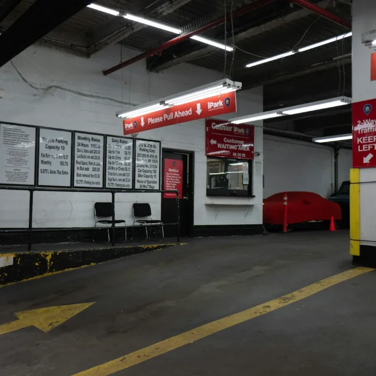 Inside an iPark parking garage in Manhattan, with pull-ahead signs and posted rates